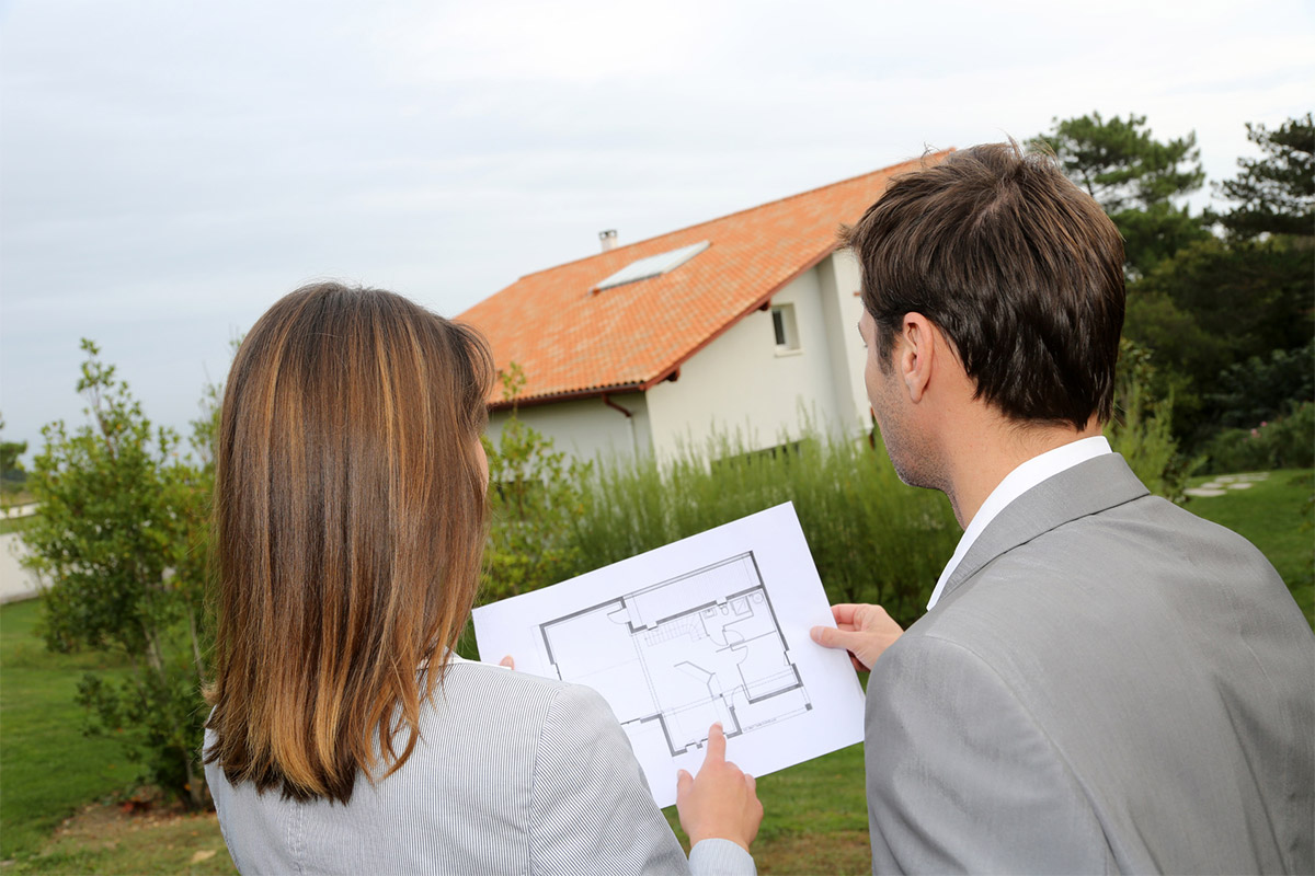 Couple looking at plans to build new house